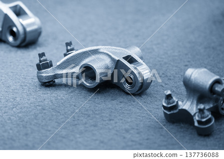 Close-up of high-precision roller rocker arm components for advanced engine valvetrain and friction reduction. Close-up of high-precision roller rocker arm components for advanced engine valvetrain and friction reduction. 137736088