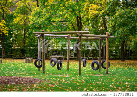View of a swing made from car tires on a playground 137738931