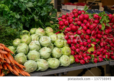 Various stacks of vegetables lie on the table for sale at the market Various stacks of vegetables lie on the table for sale at the market 137738945