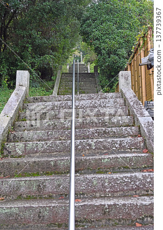 A historic stone staircase leading to a shrine situated on a hill in Uchiko, a designated Important Preservation District for Groups of Traditional Buildings. A historic stone staircase leading to a shrine situated on a hill in Uchiko, a designated Important Preservation District for Groups of Traditional Buildings. 137739367