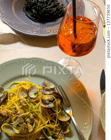 View of table set with plates of pasta dishes and cocktail View of table set with plates of pasta dishes and cocktail 137739650