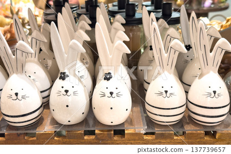 View of many decorative ceramic Easter bunnies arranged on a holiday table View of many decorative ceramic Easter bunnies arranged on a holiday table 137739657