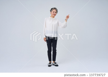 Senior woman making a gesture with her finger raised Senior woman making a gesture with her finger raised 137739727