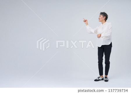 Senior woman making a gesture with her finger raised Senior woman making a gesture with her finger raised 137739734
