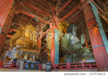 Nara, Japan - Sep 26 2024, Panoramic view of the Sitting Buddha Vairochana, a fifteen-meter bronze statue of Buddha, and a side-standing gilded statue of Buddha, at Todaiji Temple, Nara, Japan Nara, Japan - Sep 26 2024, Panoramic view of the Sitting Buddha Vairochana, a fifteen-meter bronze statue of Buddha, and a side-standing gilded statue of Buddha, at Todaiji Temple, Nara, Japan 137739812