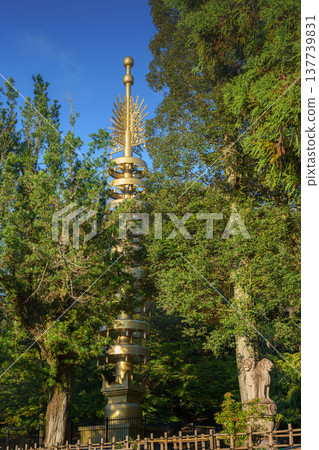 Nara, Japan - Sep 24 2025, vertical view of bronze sorin, an architectural element that decorated the top of Pagoda, surrounded by foliage of trees, in Nara Park on territory of Todaij, Nara, Japan 137739831