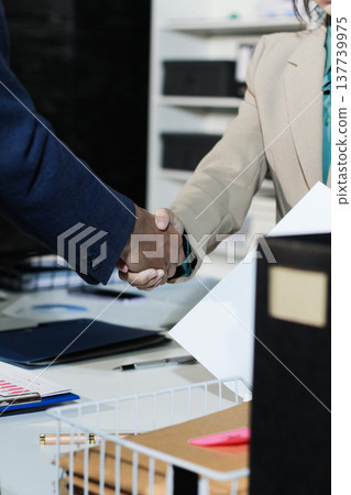 Business people shaking hands after closing a deal in lawyers office Business people shaking hands after closing a deal in lawyers office 137739975