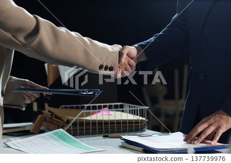 Business people shaking hands after closing a deal in lawyers office 137739976