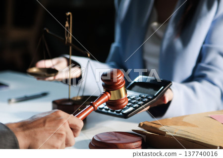 Consultation and conference of professional businesswoman and Male lawyers working and discussion having at law firm in office. Concepts of law, Judge gavel with scales of justice Consultation and conference of professional businesswoman and Male lawyers working and discussion having at law firm in office. Concepts of law, Judge gavel with scales of justice 137740016