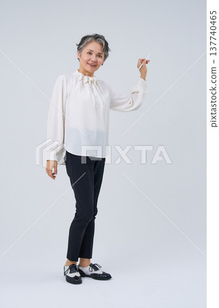 Senior woman holding a stylus pen 137740465