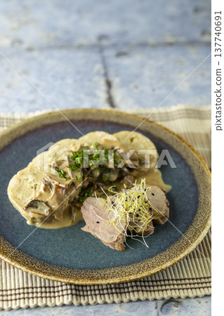 Pork tenderloin with mushroom sauce and bread dumplings Pork tenderloin with mushroom sauce and bread dumplings 137740691