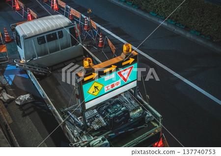 A truck loaded with an electronic display board at a construction site at night. A truck loaded with an electronic display board at a construction site at night. 137740753