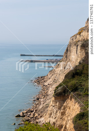 Chalk cliffs overlooking the sea and harbour at Hastings on the East Sussex coast of England. 137740761