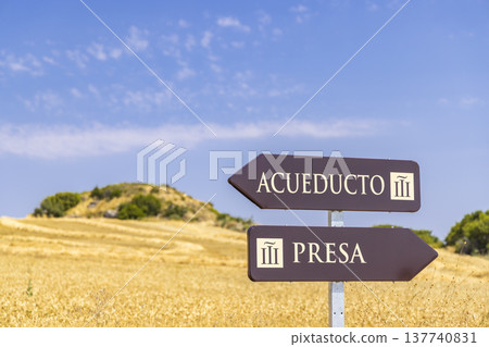 Brown signpost pointing to aqueduct and dam in field Brown signpost pointing to aqueduct and dam in field 137740831
