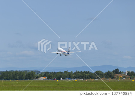 Passenger airplane taking off from airport runway 137740884