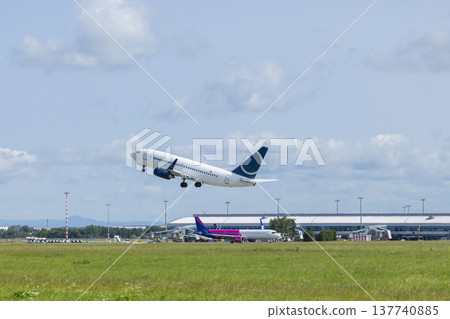 Airplane taking off from a busy international airport 137740885