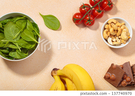 Magnesium rich foods healthy diet nutrition banana spinach nuts chocolate tomatoes copy space Magnesium rich foods healthy diet nutrition banana spinach nuts chocolate tomatoes copy space 137740970
