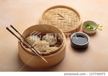 Steaming chinese dim sum bao dumplings chopsticks soy sauce asian bamboo steamer Steaming chinese dim sum bao dumplings chopsticks soy sauce asian bamboo steamer 137740975