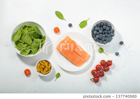Healthy anti inflammatory diet food ingredients white background salmon blueberry vegetables spinach 137740980