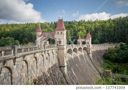 Les Kralovstvi dam historic stone reservoir with towers and bridge in forest landscape in Czech Republic Les Kralovstvi dam historic stone reservoir with towers and bridge in forest landscape in Czech Republic 137741009