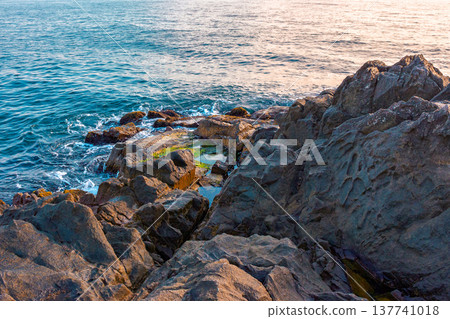 black sea coast background with rugged rock formation during summer. stone and water texture in morning light. remote place for relax. seaside picture from sozopol bay, bulgaria on a sunny weather black sea coast background with rugged rock formation during summer. stone and water texture in morning light. remote place for relax. seaside picture from sozopol bay, bulgaria on a sunny weather 137741018