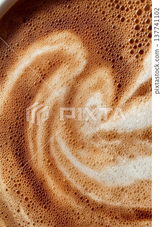 Coffee foam texture creating swirling latte art patterns. Coffee foam showing a close-up texture creating swirling latte art patterns 137741102