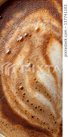 Coffee foam texture creating swirling latte art patterns. Coffee foam showing a close-up texture creating swirling latte art patterns 137741103