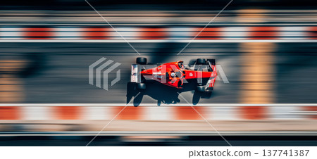 Red racing car speeding on a blurred track. Racing car creating motion blur effect on a track, viewed from above Red racing car speeding on a blurred track. Racing car creating motion blur effect on a track, viewed from above 137741387