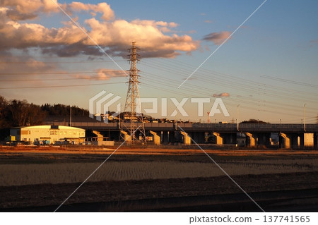 Fields at dusk, highways, power transmission towers 137741565