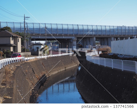 A river and a highway overpass under a blue sky. 137741566