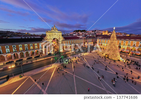 Praca do Comercio in Lisbon features a large Christmas tree and festive lights during evening twilight in winter. Lisbon, Portugal Praca do Comercio in Lisbon features a large Christmas tree and festive lights during evening twilight in winter. Lisbon, Portugal 137741686