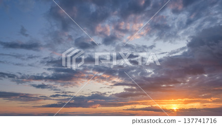 At sunset vibrant colors fill the sky, creating a stunning backdrop with dramatic clouds, perfect for relaxation and reflection. 137741716