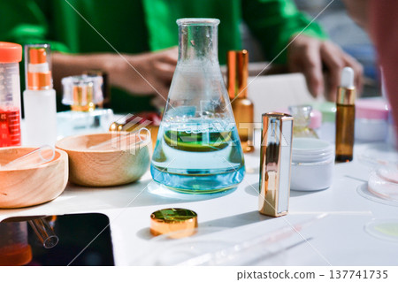 Woman making organic cosmetics with aloe in laboratory Woman making organic cosmetics with aloe in laboratory 137741735