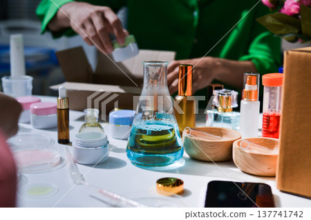 Woman making organic cosmetics with aloe in laboratory Woman making organic cosmetics with aloe in laboratory 137741742