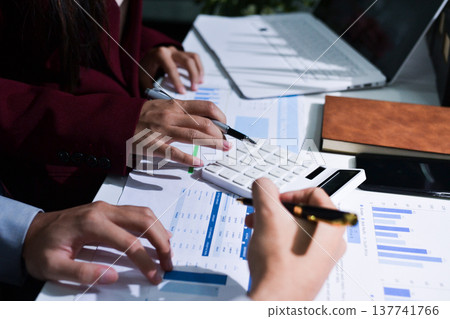 Business people analyzing monthly budget and financial report using data and chart to strategize and plan for their future business while working together in the office. Business people analyzing monthly budget and financial report using data and chart to strategize and plan for their future business while working together in the office. 137741766