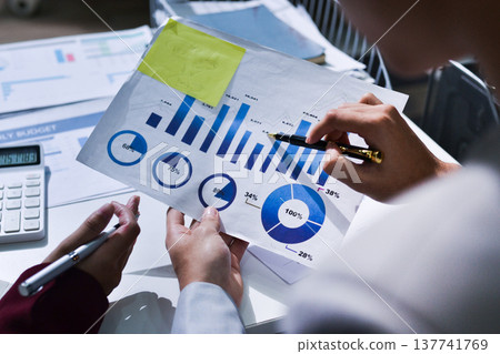 Business people analyzing monthly budget and financial report using data and chart to strategize and plan for their future business while working together in the office. Business people analyzing monthly budget and financial report using data and chart to strategize and plan for their future business while working together in the office. 137741769