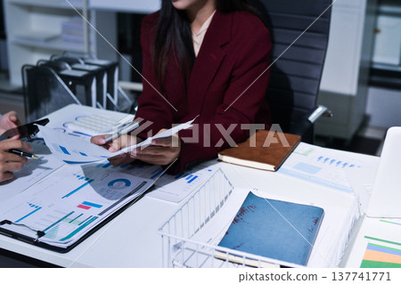 Business people analyzing monthly budget and financial report using data and chart to strategize and plan for their future business while working together in the office. 137741771