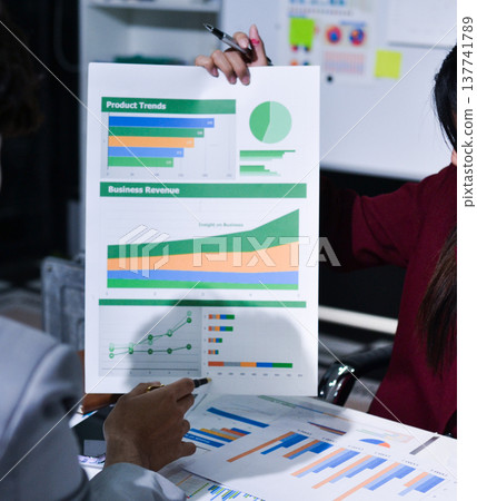 Business people analyzing monthly budget and financial report using data and chart to strategize and plan for their future business while working together in the office. Business people analyzing monthly budget and financial report using data and chart to strategize and plan for their future business while working together in the office. 137741789