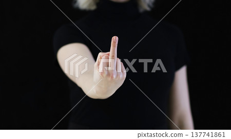 A woman's hand shows the middle finger, which signifies displeasure. A woman's hand shows the middle finger, which signifies displeasure. 137741861