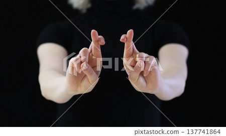 A beautiful crossed finger sign against the evil eye, from conspiracies against bad people 137741864