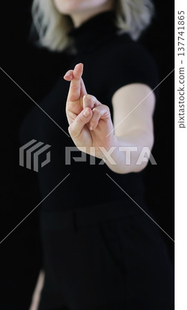 A beautiful crossed finger sign against the evil eye, from conspiracies against bad people A beautiful crossed finger sign against the evil eye, from conspiracies against bad people 137741865