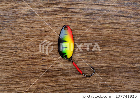 Fishing lure on the old wooden table. Fishing lure on the old wooden table. 137741929