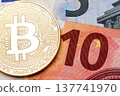 Ten euro banknote as a background for golden bitcoin. 137741970