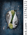 fresh, raw dorado fish, on a dark blue background, top view, two pieces, no people, 137742172