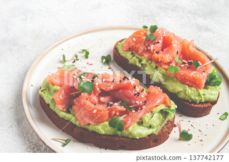 breakfast, Sandwiches with smoked salmon and avocado, on dark rye bread, with microgreens, on a marble table, homemade, no people, breakfast, Sandwiches with smoked salmon and avocado, on dark rye bread, with microgreens, on a marble table, homemade, no people, 137742177