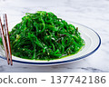 Chuka salad, made from fresh seaweed, with sesame dressing, served on a white plate, with chopsticks, no people, 137742186