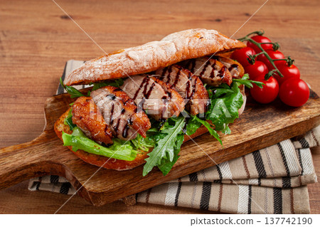 sandwich with duck breast and arugula, balsamic sauce, on a wooden chopping board, breakfast, homemade, without people, sandwich with duck breast and arugula, balsamic sauce, on a wooden chopping board, breakfast, homemade, without people, 137742190
