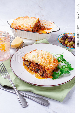 Moussaka served with olives, in a bright kitchen setting, homemade, no people, Moussaka served with olives, in a bright kitchen setting, homemade, no people, 137742200