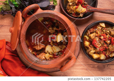 Chanakhi, a Georgian dish. in a clay pot, on a wooden table, stewed meat with vegetables, homemade, no people, Chanakhi, a Georgian dish. in a clay pot, on a wooden table, stewed meat with vegetables, homemade, no people, 137742205