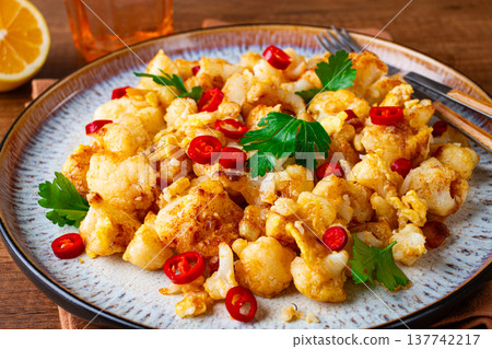 spicy fried cauliflower served on a wooden countertop, spicy fried cauliflower served on a wooden countertop, 137742217